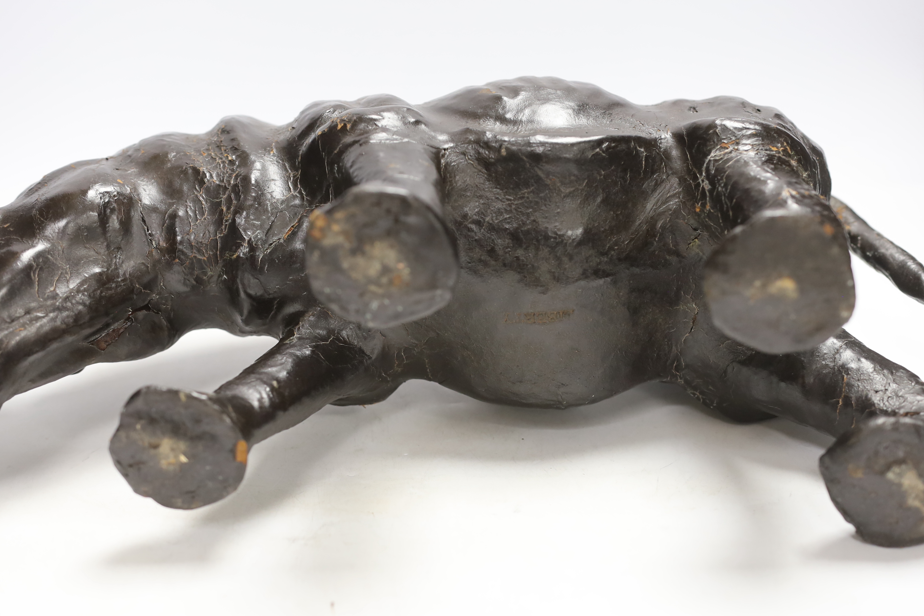 A leather rhinoceros figure with glass eyes, stamped Liberty to the underside, 54cm wide